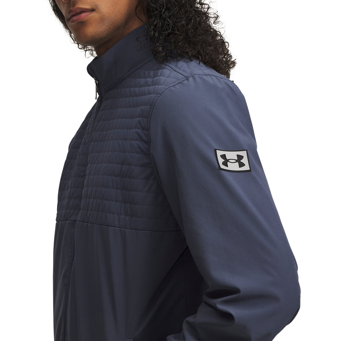 Person wearing a downpour grey jacket with Under Armour logo on sleeve