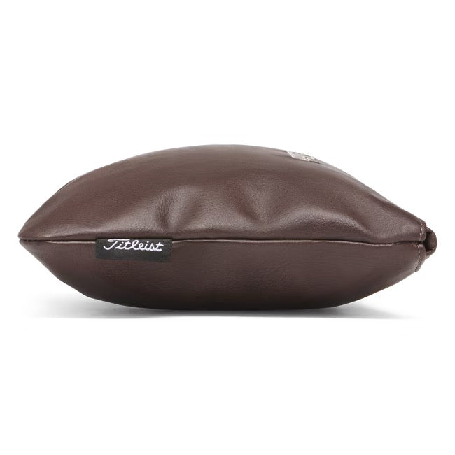 Side view of a brown leather Titleist Birthplace of Golf zippered valuables pouch with a black branded side tab.