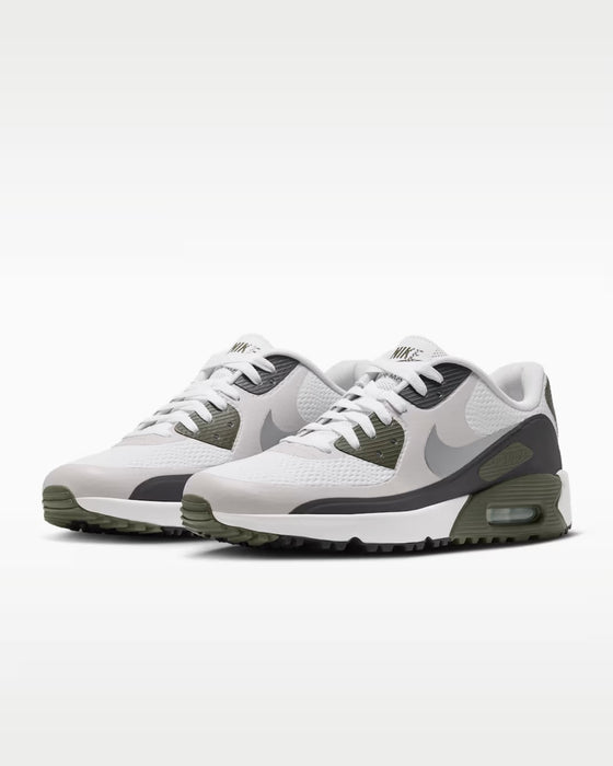 Nike Air Max 90 Golf shoes in white and olive green with a mesh upper and textured rubber outsole, side view.