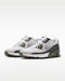 Nike Air Max 90 Golf shoes in white and olive green with a mesh upper and textured rubber outsole, side view.