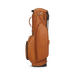 A side profile view of a tan leather Titleist LINKSLEGEND Classic Members II Golf Stand Bag with a telescoping handle and multiple zippered pockets, set against a plain white background.