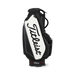 A Titleist Tour Series Tour Golf Bag II in black and white, featuring a large white front panel with the black Titleist logo script, set against a plain white background.