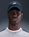 Nike Club Futura Unstructured Golf Cap in obsidian blue with a white logo, worn by a model in a front-facing view.