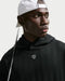 Nike Fairway Fresh oversized black golf hoodie with ribbed texture and chest crest logo, front view.