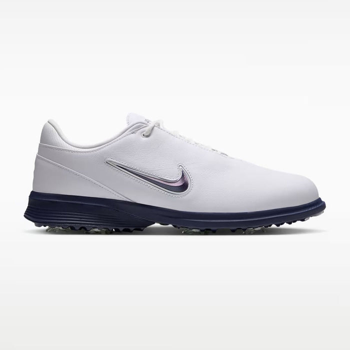 Nike Victory Tour 4 golf shoes in white and midnight navy, side view featuring a sleek leather design and spiked sole.
