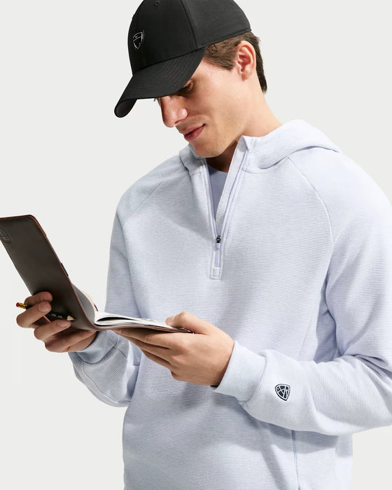Nike Par Men's Therma-FIT golf hoodie in light blue with a quarter-zip front, textured fabric, and sleeve logo detail.