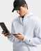 Nike Par Men's Therma-FIT golf hoodie in light blue with a quarter-zip front, textured fabric, and sleeve logo detail.