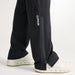 PING AquaDrive Pro black waterproof golf over trousers showing side leg zip detail and branding.