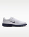 Nike Victory Tour 4 golf shoe in white leather with a navy blue midsole and side swoosh, side view.