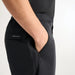 Side view of black PING AquaDrive Pro waterproof golf trousers featuring a Sensordry pocket detail.