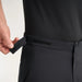 PING AquaDrive Pro men's black waterproof golf trousers, showing a close-up of the adjustable velcro waist tab.