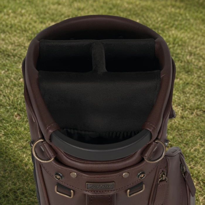 Top-down view of a brown leather Titleist LINKSLEGEND golf bag showing the black lined club dividers and metal hardware.