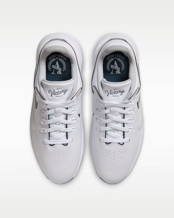 Top-down view of white Nike Victory Pro 4 golf shoes with lace-up closure and branded insoles.