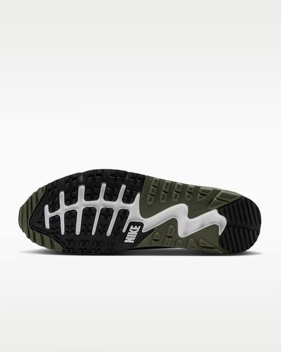 Nike Air Max 90 Golf shoes showing the black, olive green, and white textured rubber traction outsole from below.