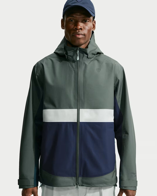 Nike Par Storm-FIT ADV waterproof golf jacket in camo green and navy blue with a front zip and hood, front view.