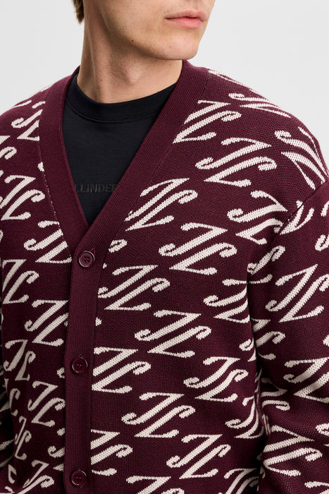 close up on model of the J.Lindeberg Denny Jacquard Knitted Cardigan in burgndy