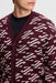 close up on model of the J.Lindeberg Denny Jacquard Knitted Cardigan in burgndy