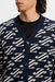 close up on model of the J.Lindeberg Denny Jacquard Knitted Cardigan in navy