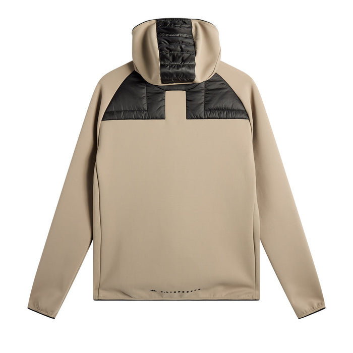 back of J.Lindeberg Heyden Quilt Hybrid Hood Golf Jacket in beige and black