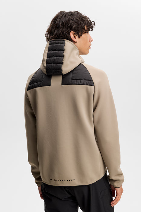 J.Lindeberg Heyden Quilt Hybrid Hood Golf Jacket in beige on model 