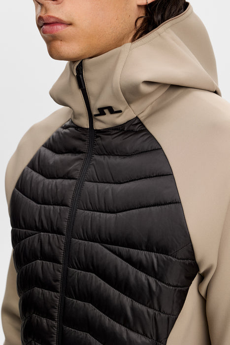 close up of J.Lindeberg Heyden Quilt Hybrid Hood Golf Jacket in beige on model
