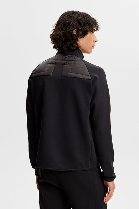 J.Lindeberg Heyden Quilt Hybrid Golf Jacket in black on away facing male model
