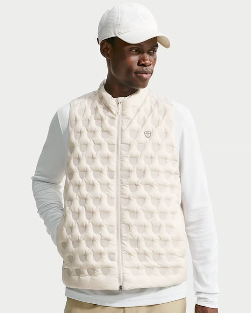 Nike Therma-FIT ADV Repel golf gilet in light orewood brown with a quilted front, zip-up design, and chest logo.