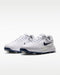 Nike Victory Pro 4 golf shoes in white with navy blue swoosh, featuring a sleek synthetic upper and spiked sole.