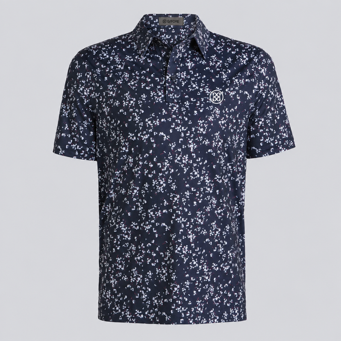 A short-sleeve button-up G/FORE Wild FlowerTech Jersey Men's Golf Polo Shirt navy blue with a dense white floral print, featuring a small embroidered monogram logo on the left chest, displayed on a neutral light grey background.