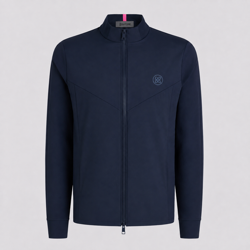 A navy blue G/FORE Storm Fleece Hybrid Men's Golf Jacket stand-up collar, featuring a subtle tonal embroidered logo on the left chest and a small pink accent tab inside the collar, shown against a light grey background.