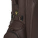 Close-up of the brown leather Titleist LINKSLEGEND Members golf bag showing the branded metal emblem and side pocket.