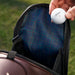 Titleist LINKSLEGEND golf bag pocket with blue tartan lining and a hand holding a white Titleist golf ball.