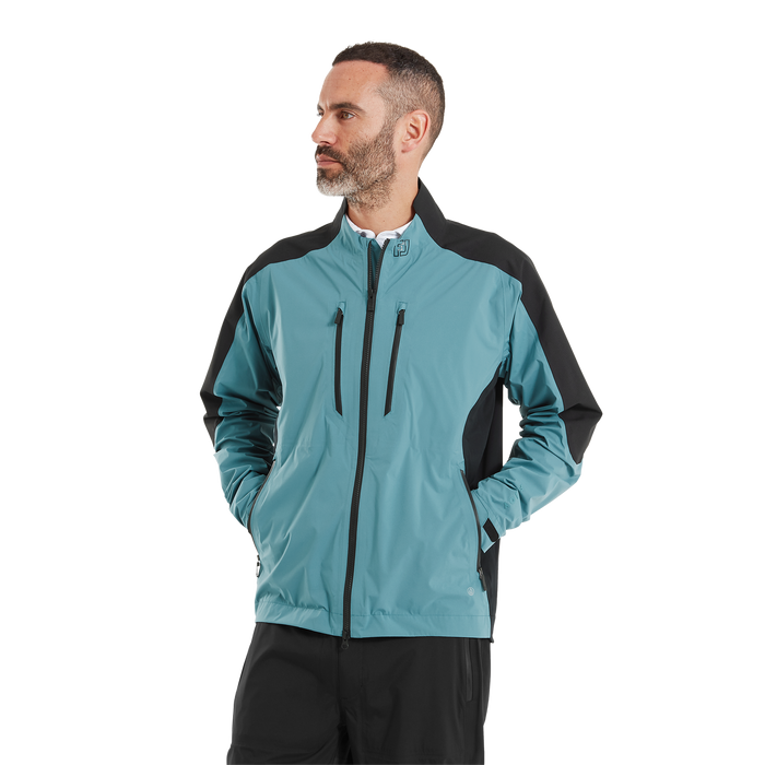 FootJoy ARCUS men's waterproof golf jacket in teal and black, featuring a full-zip front and chest pockets.