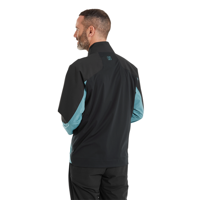 FootJoy ARCUS Men's Waterproof Golf Jacket in black and teal, rear view showing high collar and FJ logo branding.