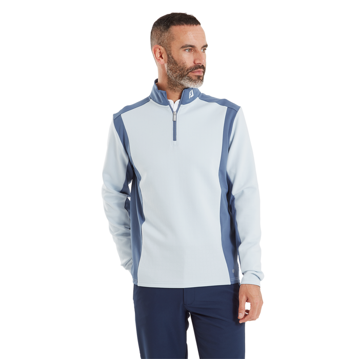 FootJoy ThermoSeries Blocked golf midlayer in light blue and navy, featuring a quarter-zip collar and textured fabric.