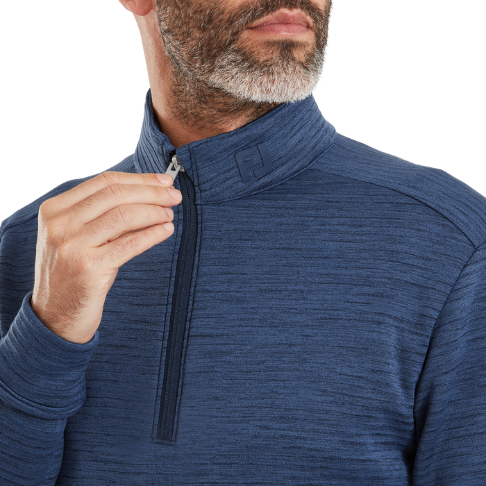 FootJoy ThermoSeries space dye golf midlayer in blue, featuring a quarter-zip neck and embroidered FJ logo detail.
