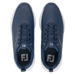 Top-down view of navy blue FootJoy Qualifier men's spiked golf shoes with white midsoles and perforated detailing.