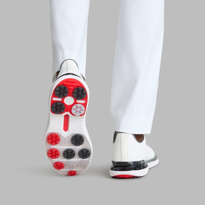 G/FORE Gallivan2R Camo Welt Spikeless Golf Shoes in white with camo welt, view of the multi coloured sole on a model