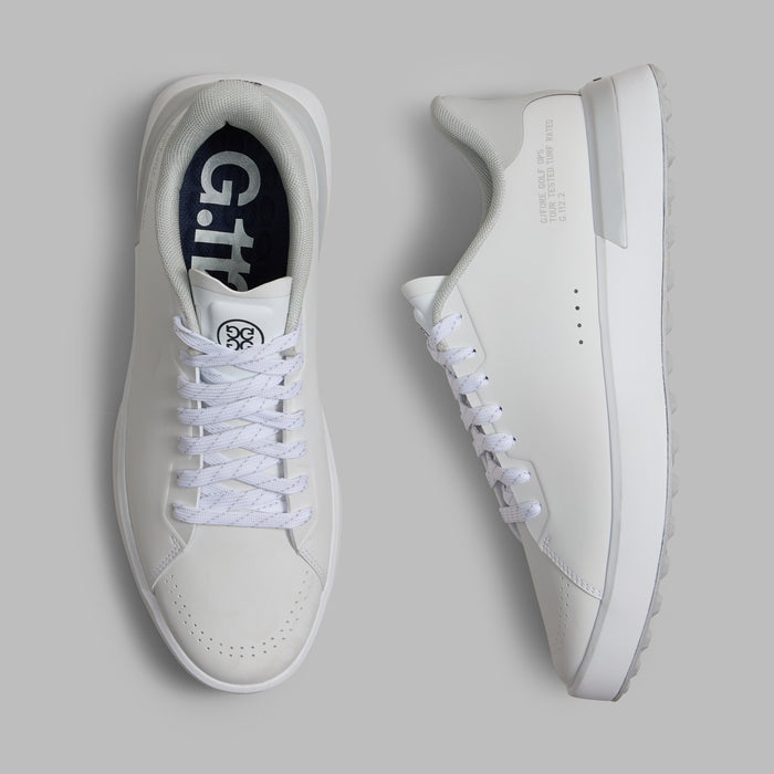 G/FORE G.112 Camo Spikeless Golf Shoes in white and grey, view from above with one shoe on its side