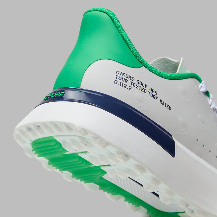 G/FORE G.112 Embossed Skull & Tees Spikeless Golf Shoes in white with green and navy accents, close up of the heel