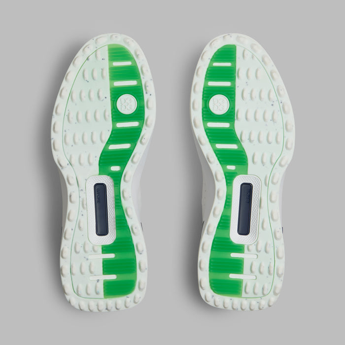 G/FORE G.112 Embossed Skull & Tees Spikeless Golf Shoes in white with green and navy accents, view of the soles of both shoes