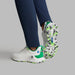 G/FORE MG4+ O2 Perforated Men's Spikeless Golf Shoes in white and green, view of the pair on a model with the model lifting his right foot