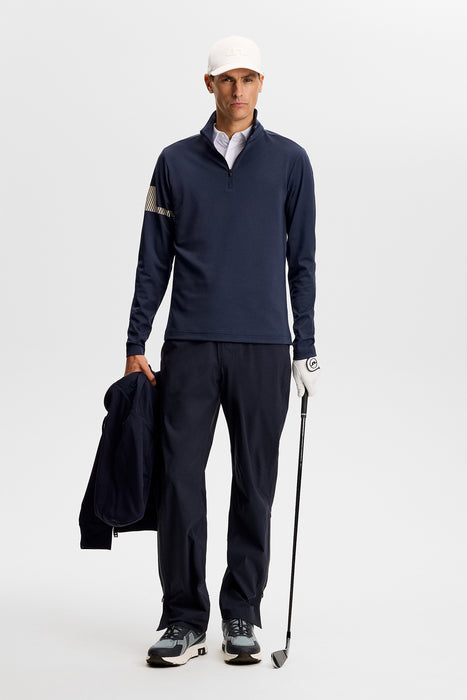 J.Lindeberg Heath Strike Quarter Zip Golf Mid Layer in jl navy, on model holding golf club