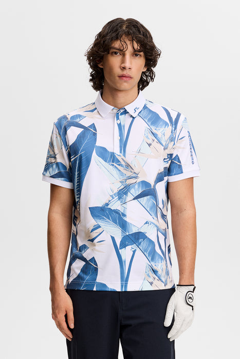 J.Lindeberg Tour Tech Print Golf Polo Shirt in paradise skylight, all over leaf print. shown on model facing forwards