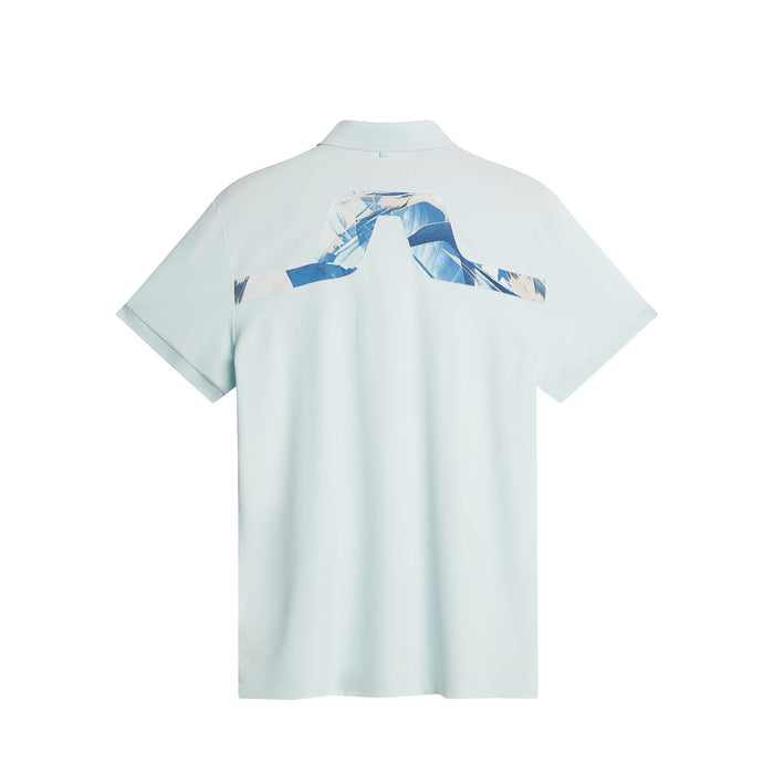 J.Lindeberg KV Print Golf Polo Shirt in paradise skylight. Showing the printed bridge logo on the back