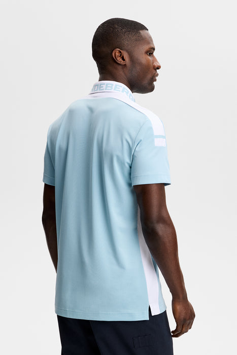 J.Lindeberg Bo Polo Golf Shirt in light blue on model facing away showing the back of the polo