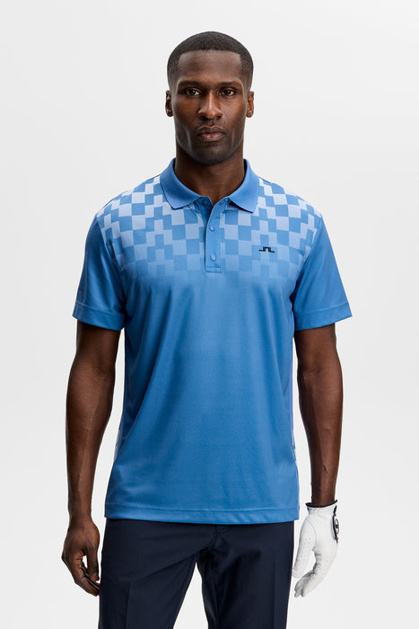 J.Lindeberg Finn Print Golf Polo Shirt in federal blue and white on model facing forwards showing whole front