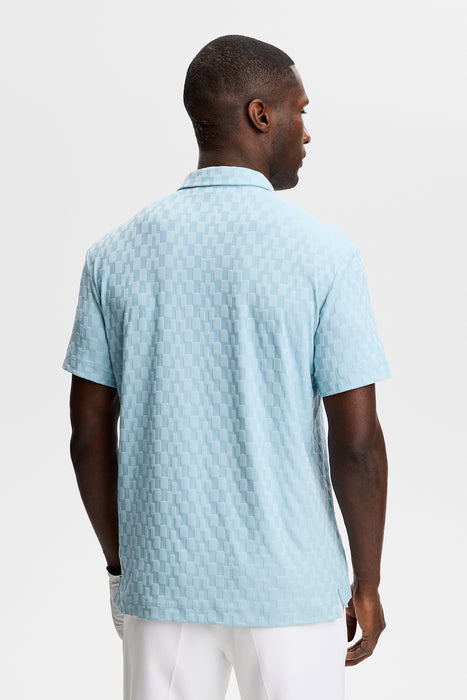 J.Lindeberg Kofe Golf Polo Shirt in light blue on model who is facing away showing the back of the shirt