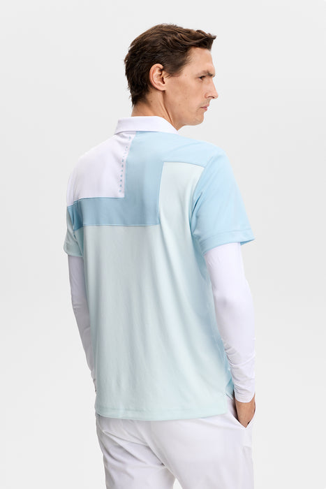 J.Lindeberg Rody Golf Polo Shirt in skylight blue on a model facing away showing the back design
