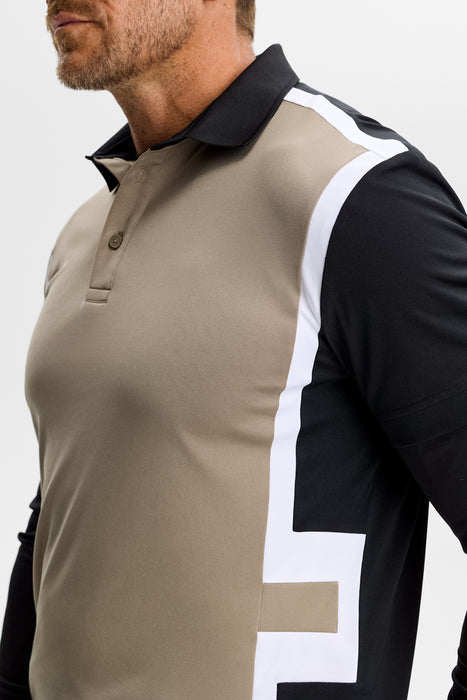 close up on model of the J.Lindeberg Finn Golf Polo Shirt in black and beige